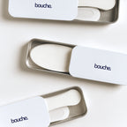 Bouche sleep mouth tape and nasal strips products in metal cases on a white background